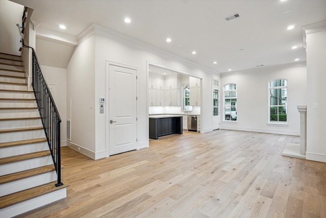 213 Sutton Row Pl, Houston, TX 77024 - unfurnished living room with ornamental molding, stairway, recessed lighting, light wood-style flooring, and baseboards