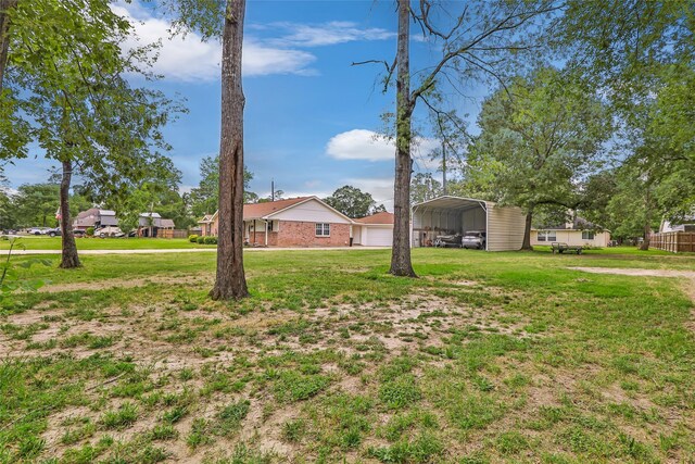 3303 Indian Mound Trl, Crosby, TX 77532 - view of green lawn with a carport