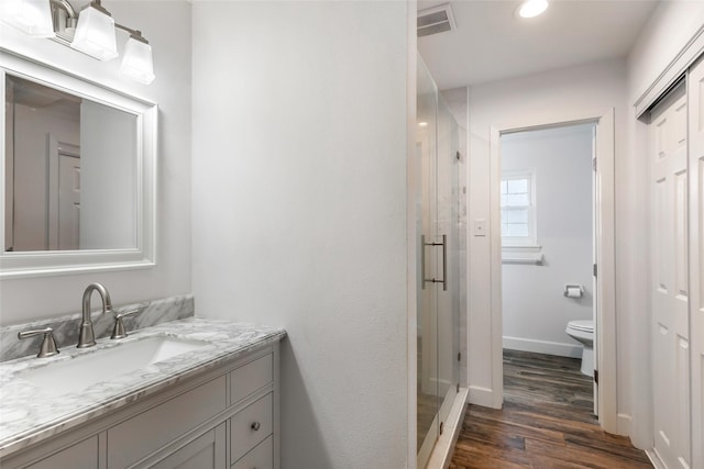 3303 Indian Mound Trl, Crosby, TX 77532 - bathroom featuring toilet, a shower stall, vanity, wood finished floors, and recessed lighting