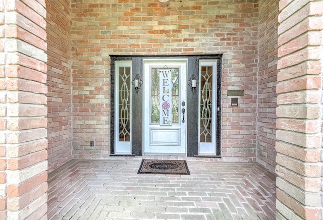 9911 Oxted Ln, Spring, TX 77379 - view of exterior entry featuring brick siding