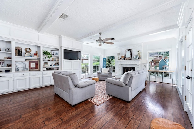 9911 Oxted Ln, Spring, TX 77379 - living area with a textured ceiling, a brick fireplace, ceiling fan, crown molding, and beamed ceiling
