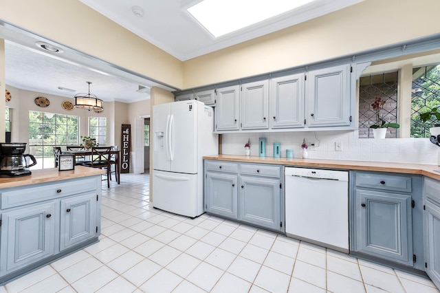 9911 Oxted Ln, Spring, TX 77379 - kitchen featuring white appliances, butcher block countertops, crown molding, tasteful backsplash, and decorative light fixtures