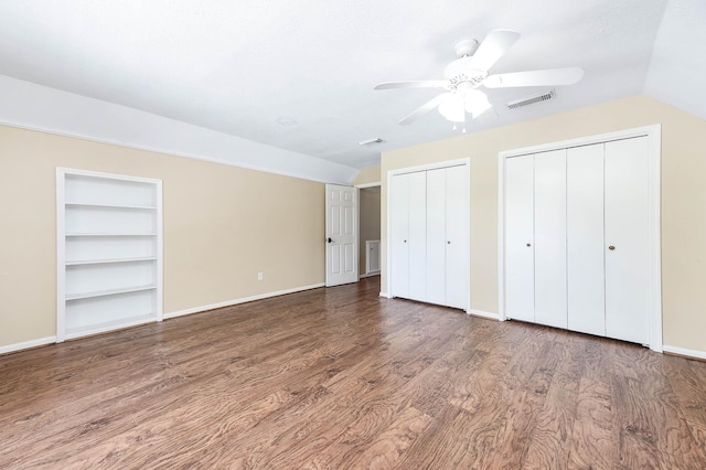 9911 Oxted Ln, Spring, TX 77379 - unfurnished bedroom featuring wood finished floors, multiple closets, baseboards, a ceiling fan, and vaulted ceiling