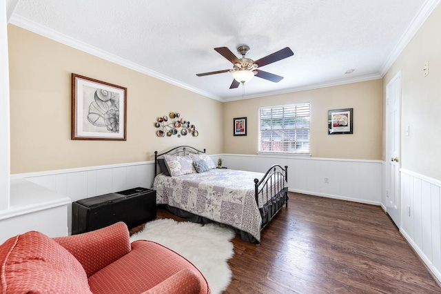 9911 Oxted Ln, Spring, TX 77379 - bedroom featuring ornamental molding, wood finished floors, wainscoting, a textured ceiling, and ceiling fan