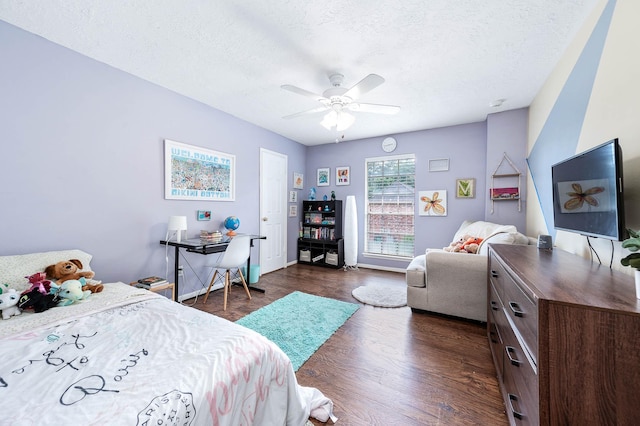 9911 Oxted Ln, Spring, TX 77379 - bedroom with dark wood-type flooring, a textured ceiling, ceiling fan, and baseboards