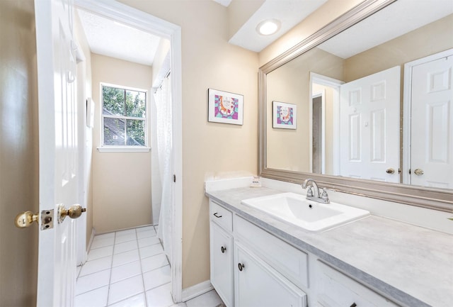 9911 Oxted Ln, Spring, TX 77379 - bathroom featuring vanity, tile patterned floors, and baseboards