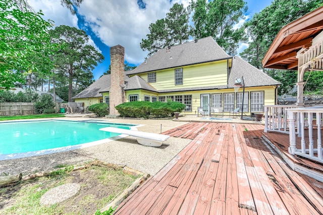9911 Oxted Ln, Spring, TX 77379 - view of swimming pool featuring a wooden deck, a diving board, and a patio area