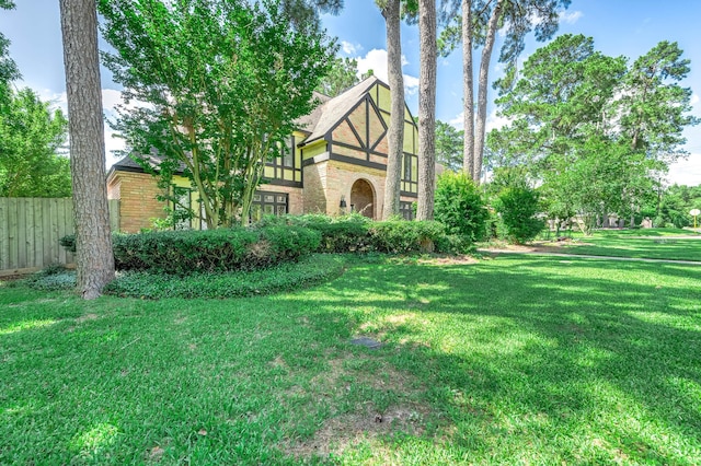 9911 Oxted Ln, Spring, TX 77379 - tudor home featuring brick siding