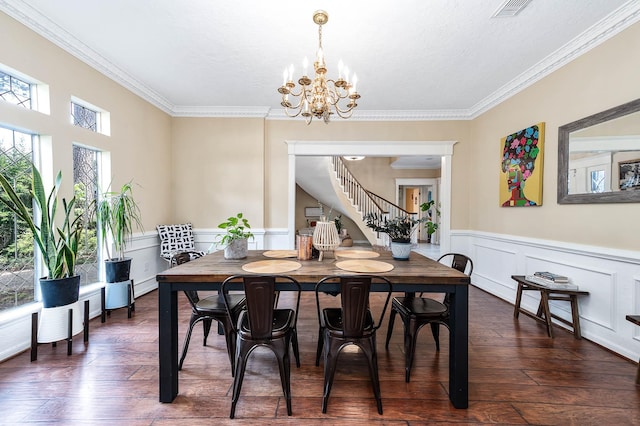 9911 Oxted Ln, Spring, TX 77379 - dining room with stairs, crown molding, dark wood-style flooring, a chandelier, and wainscoting