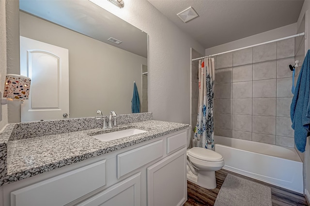 15055 Meadow Gln N, Conroe, TX 77306 - bathroom with wood finished floors, vanity, toilet, and shower / tub combo