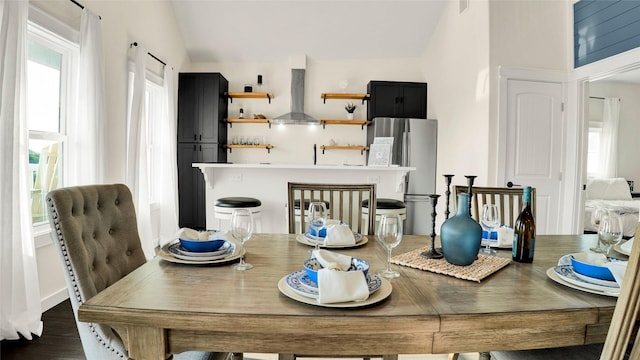 1066 Shady Ln, Gilchrist, TX 77650 - dining room with lofted ceiling and dark wood-style flooring
