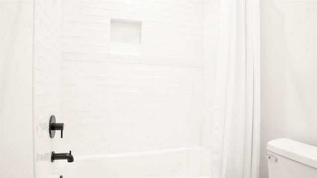 1066 Shady Ln, Gilchrist, TX 77650 - bathroom with toilet and shower / bath combination with curtain