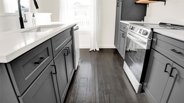 1066 Shady Ln, Gilchrist, TX 77650 - kitchen with gray cabinetry, stainless steel range with electric stovetop, a sink, open shelves, and dark wood-style floors