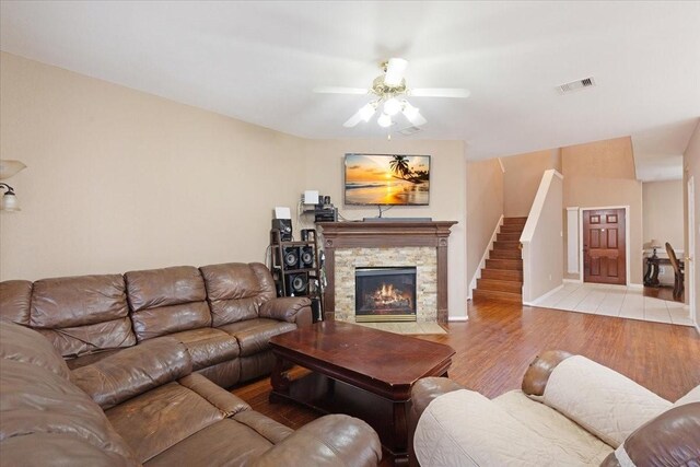 8418 Kirkbrook Dr, Houston, TX 77089 - living room with wood finished floors, ceiling fan, a fireplace, stairs, and baseboards