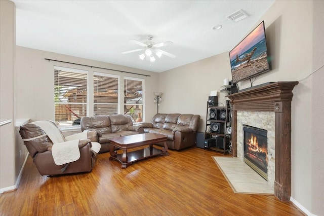8418 Kirkbrook Dr, Houston, TX 77089 - living area featuring a ceiling fan, wood finished floors, a fireplace, and baseboards