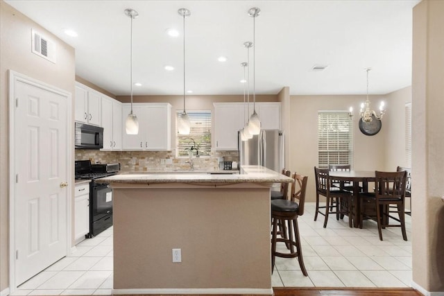8418 Kirkbrook Dr, Houston, TX 77089 - kitchen featuring black appliances, decorative backsplash, light tile patterned flooring, and recessed lighting