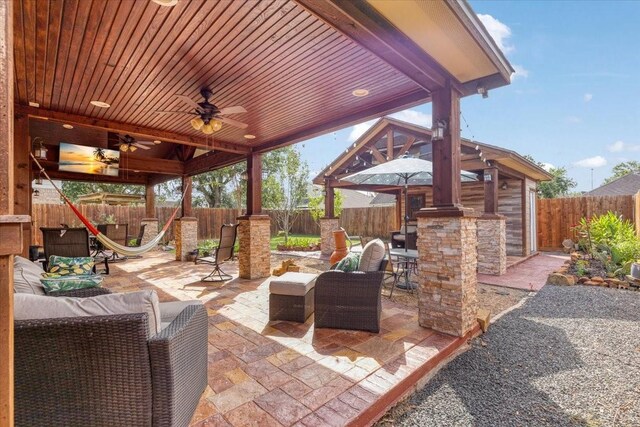 8418 Kirkbrook Dr, Houston, TX 77089 - fenced backyard with a patio, ceiling fan, an outdoor hangout area, and a gazebo