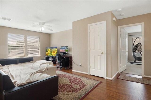 8418 Kirkbrook Dr, Houston, TX 77089 - bedroom with an office area, wood finished floors, baseboards, and a ceiling fan
