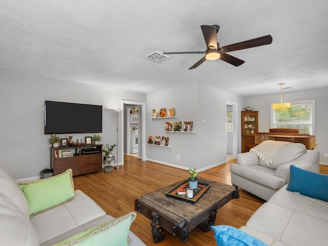 110 Marshall St, League City, TX 77573 - living room featuring a ceiling fan, wood finished floors, and baseboards