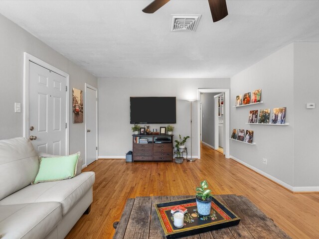 110 Marshall St, League City, TX 77573 - living room featuring ceiling fan, wood finished floors, and baseboards