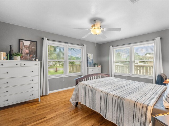 110 Marshall St, League City, TX 77573 - bedroom with light wood-style flooring, baseboards, and a ceiling fan