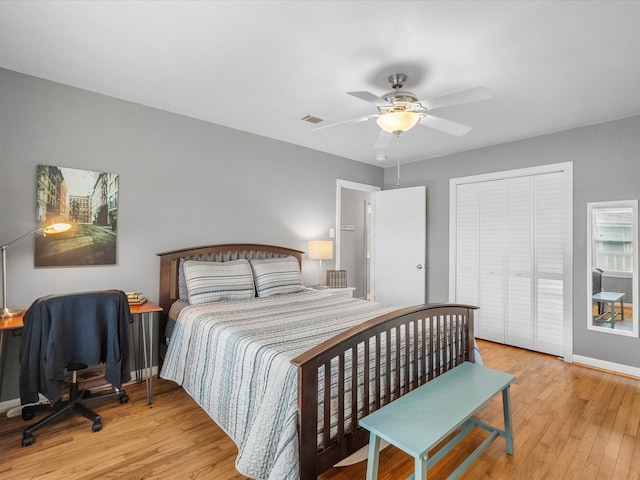110 Marshall St, League City, TX 77573 - bedroom with light wood-style floors, a closet, a ceiling fan, and baseboards