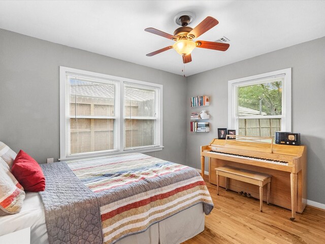 110 Marshall St, League City, TX 77573 - bedroom featuring multiple windows, wood finished floors, a ceiling fan, and baseboards