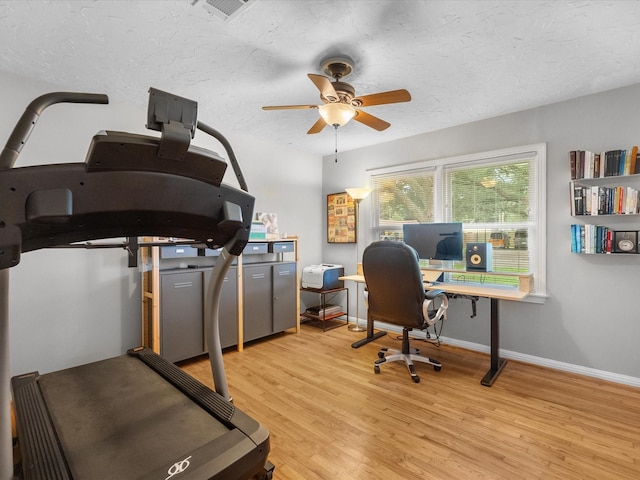 110 Marshall St, League City, TX 77573 - home office featuring a ceiling fan, light wood-type flooring, baseboards, and a textured ceiling