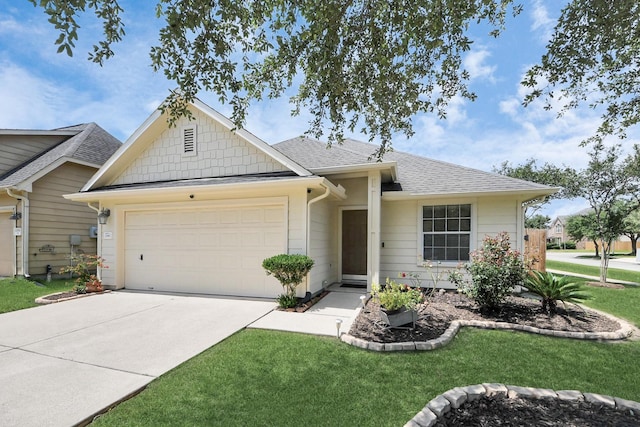 12943 Palm Leaf Ct, Houston, TX 77044 - view of front facade with a garage, roof with shingles, driveway, and a front yard