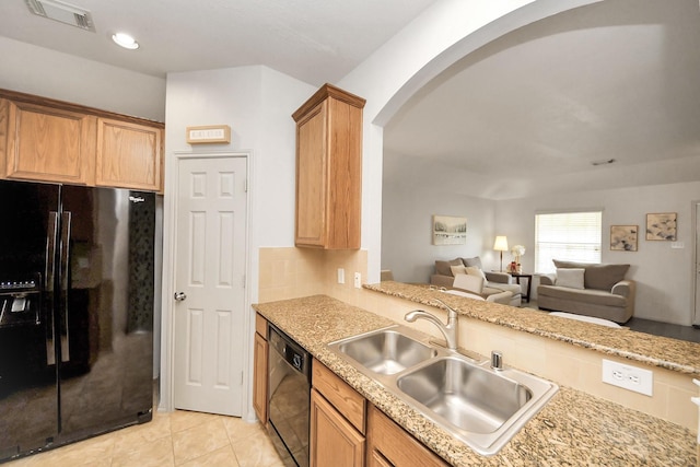 12943 Palm Leaf Ct, Houston, TX 77044 - kitchen featuring black appliances, a sink, arched walkways, backsplash, and open floor plan
