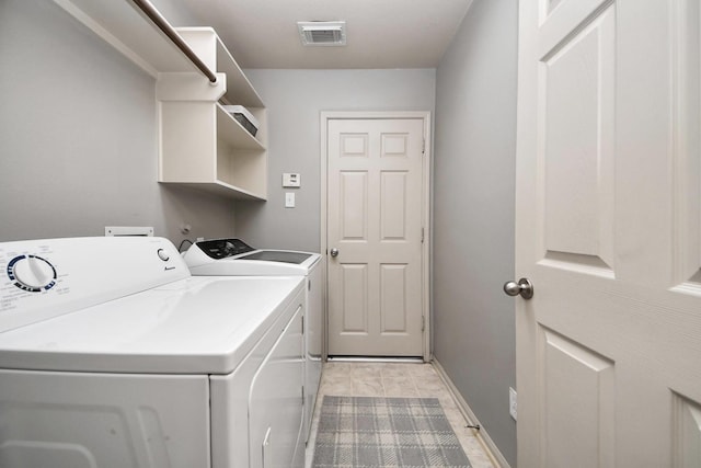 12943 Palm Leaf Ct, Houston, TX 77044 - laundry area featuring washer and clothes dryer, baseboards, and light tile patterned flooring