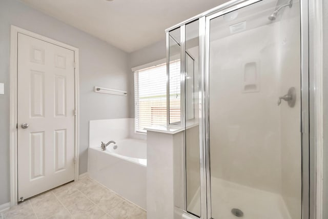 12943 Palm Leaf Ct, Houston, TX 77044 - full bathroom featuring a garden tub, a stall shower, tile patterned floors, and baseboards