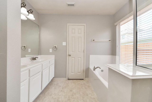 12943 Palm Leaf Ct, Houston, TX 77044 - full bath with double vanity, a garden tub, and tile patterned floors