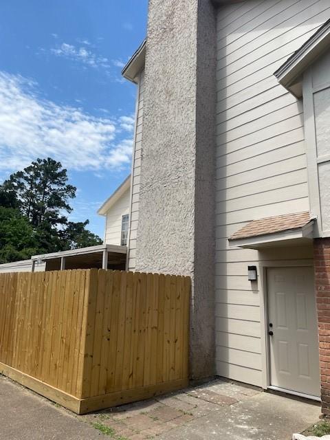 12239 W Village Dr Unit A, Houston, TX 77039 - view of property exterior featuring a chimney