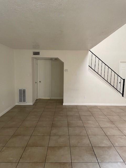 12239 W Village Dr Unit A, Houston, TX 77039 - tiled spare room featuring baseboards
