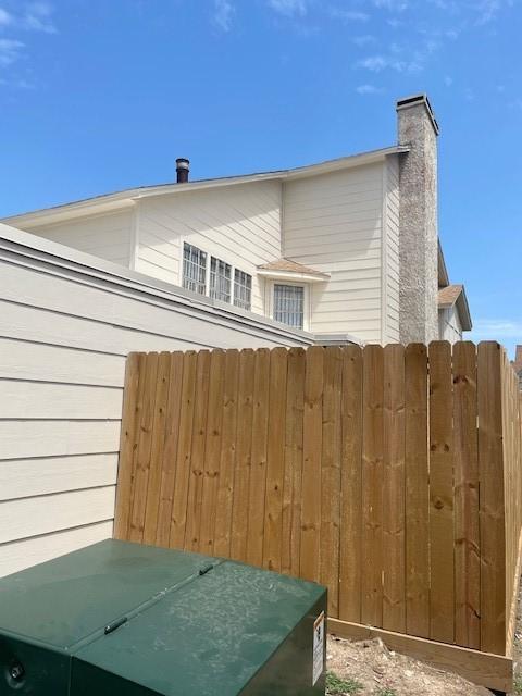 12239 W Village Dr Unit A, Houston, TX 77039 - view of property exterior featuring a chimney