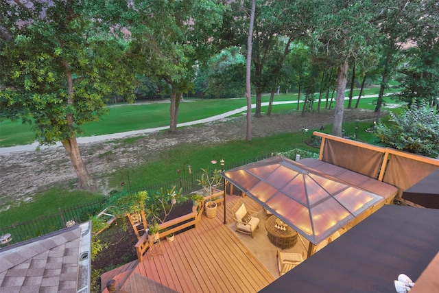 167 Monterrey Rd E, Montgomery, TX 77356 - wooden terrace featuring outdoor dining area, a lawn, and view of wooded area