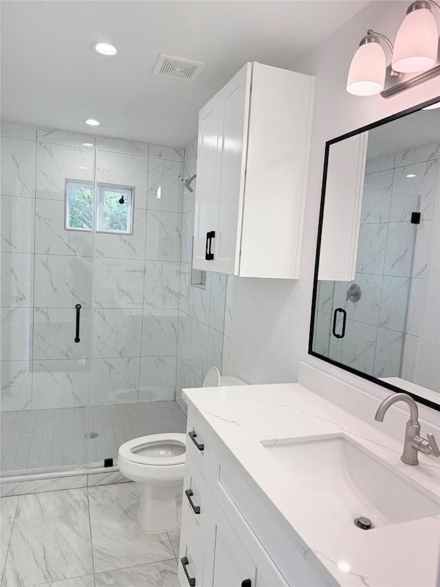 115 Penick Rd, Waller, TX 77484 - bathroom with marble look tiles, vanity, toilet, a marble finish shower, and recessed lighting