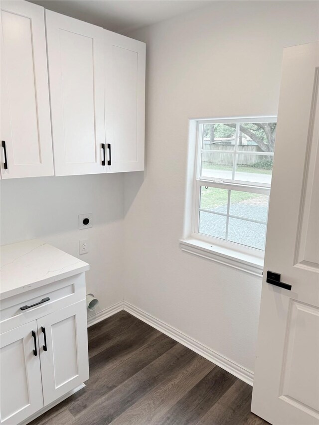 115 Penick Rd, Waller, TX 77484 - laundry room featuring cabinet space, dark wood finished floors, electric dryer hookup, and baseboards