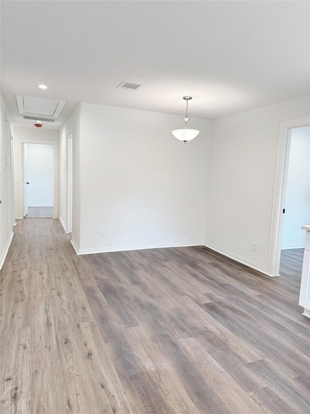 115 Penick Rd, Waller, TX 77484 - empty room featuring attic access, wood finished floors, and baseboards