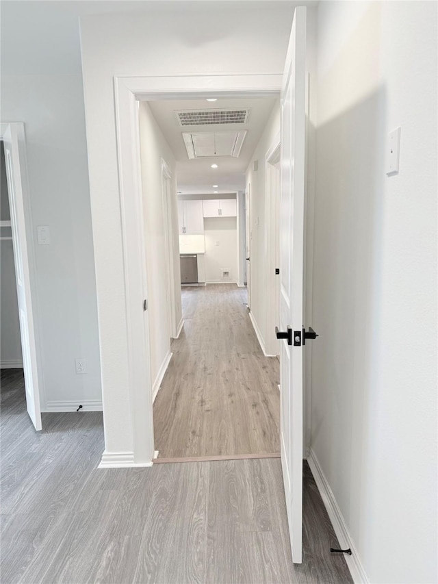 115 Penick Rd, Waller, TX 77484 - corridor with light wood-style flooring, attic access, and baseboards