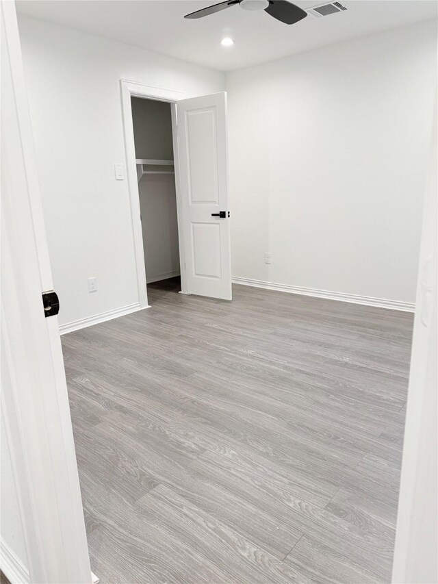 115 Penick Rd, Waller, TX 77484 - unfurnished bedroom featuring wood finished floors, baseboards, recessed lighting, ceiling fan, and a closet