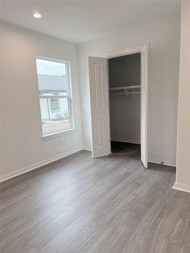 115 Penick Rd, Waller, TX 77484 - unfurnished bedroom featuring wood finished floors, baseboards, a closet, and recessed lighting