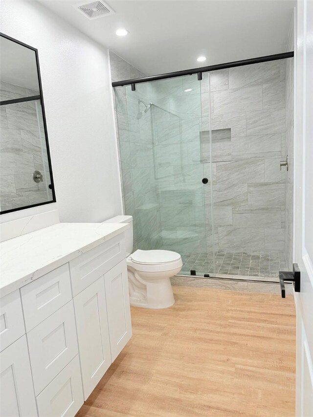 115 Penick Rd, Waller, TX 77484 - full bath with toilet, wood finished floors, vanity, a stall shower, and recessed lighting
