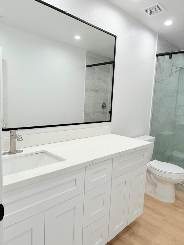 115 Penick Rd, Waller, TX 77484 - full bath featuring a shower stall, vanity, toilet, wood finished floors, and recessed lighting
