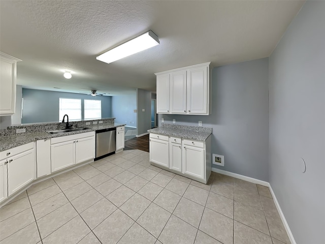 422 Magnolia Way, League City, TX 77573 - kitchen with dishwasher, a sink, light tile patterned floors, white cabinets, and baseboards