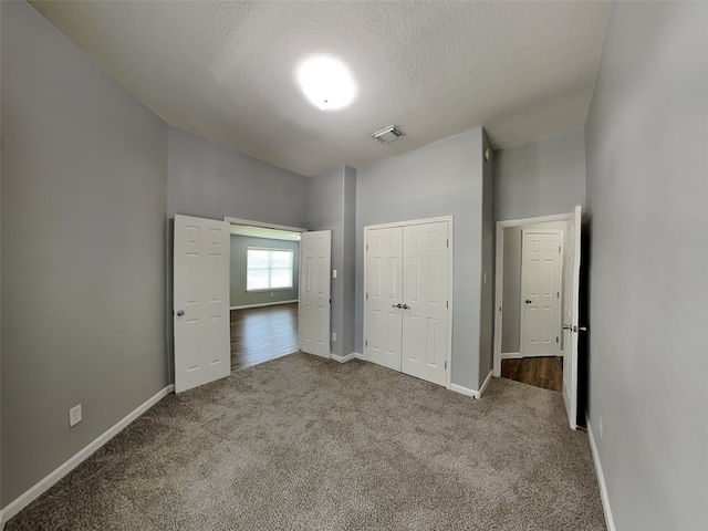 422 Magnolia Way, League City, TX 77573 - unfurnished bedroom with carpet, baseboards, high vaulted ceiling, a closet, and a textured ceiling