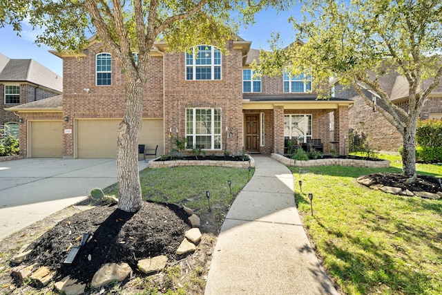 25611 Kearsley Dr, Katy, TX 77494 - traditional-style house featuring brick siding, a front yard, concrete driveway, and a garage
