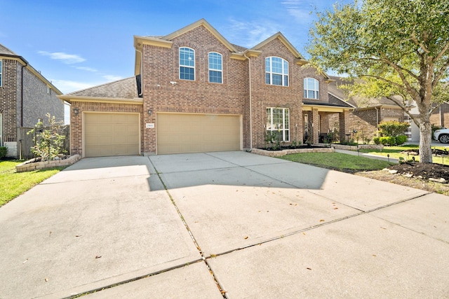 25611 Kearsley Dr, Katy, TX 77494 - traditional-style house featuring brick siding, driveway, an attached garage, and a shingled roof