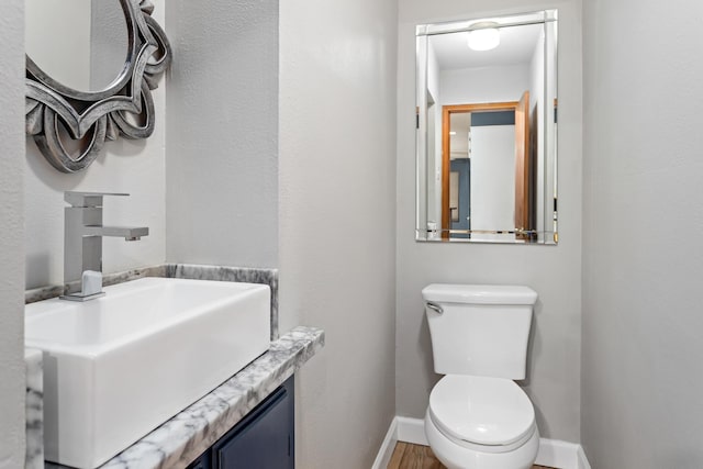 11161 Blue Bonnet Ln, Beaumont, TX 77705 - half bathroom with baseboards, toilet, and vanity